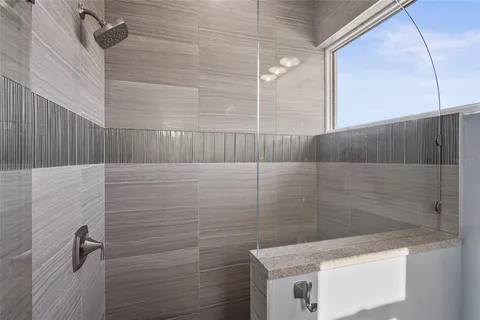 an aerial view of a house with a garden and lake view