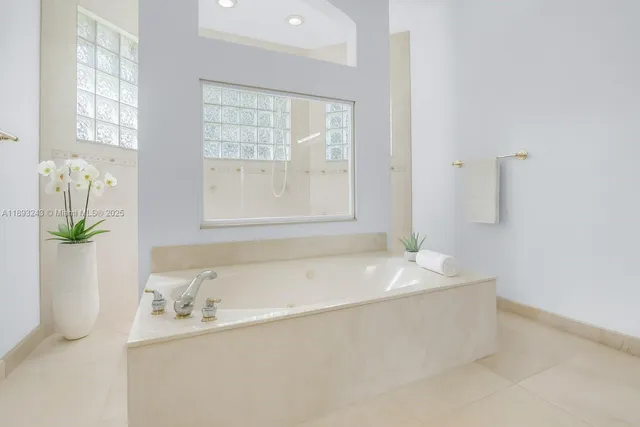 a bathroom with a sink a vanity a mirror and a bathtub