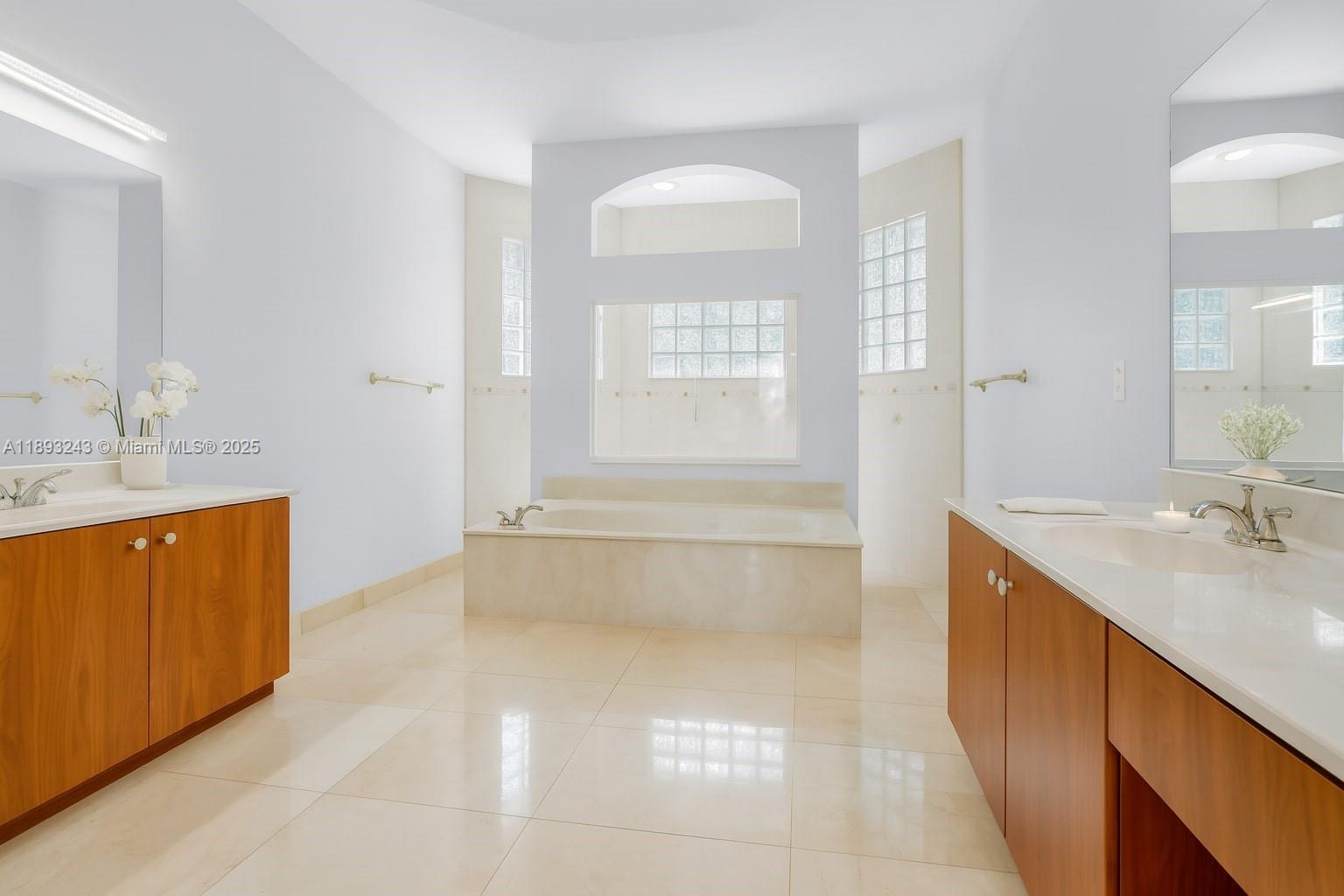 14032 Northwest 15th Street Pembroke Pines, FL 33028 - Photo 15 of 55 a bathroom with a sink a vanity a mirror and a bathtub