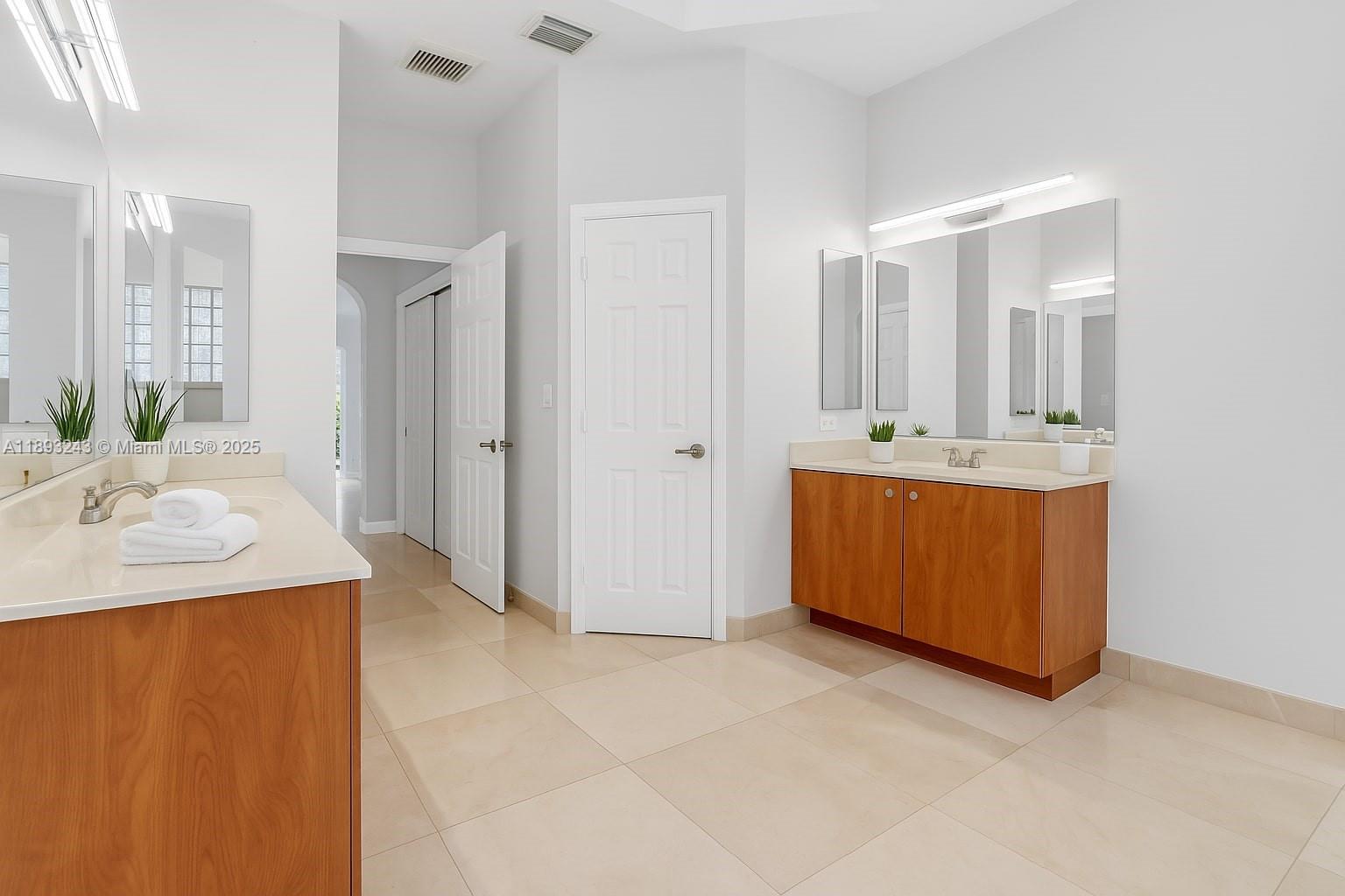 14032 Northwest 15th Street Pembroke Pines, FL 33028 - Photo 16 of 55 a bathroom with a tub sink and mirror