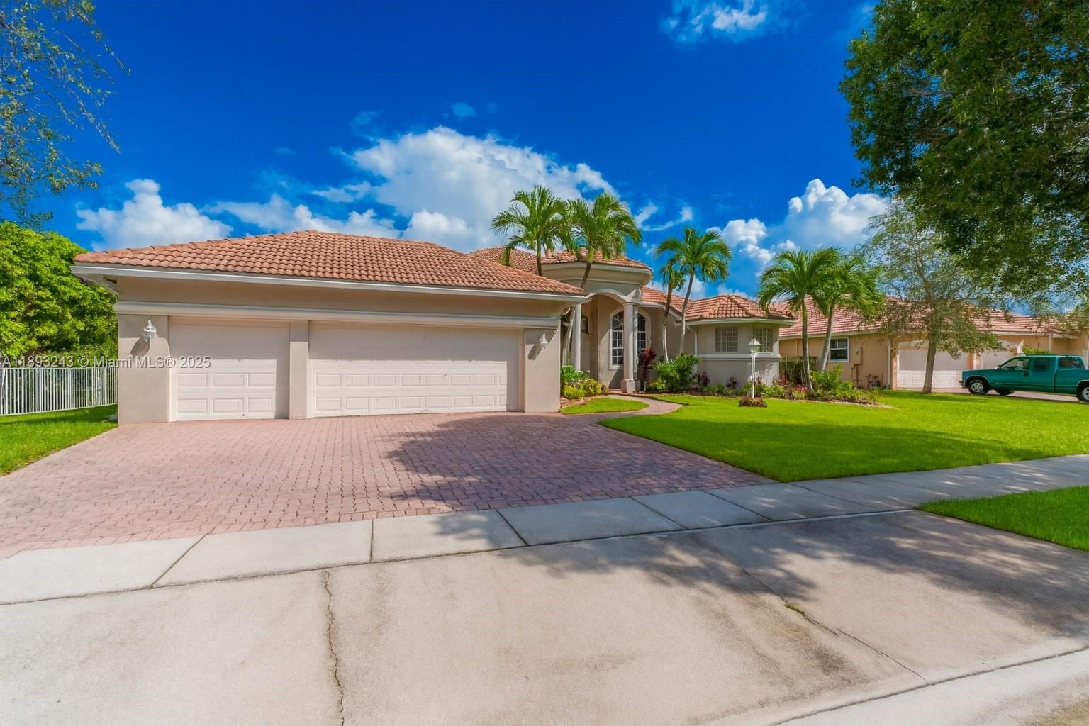 14032 Northwest 15th Street Pembroke Pines, FL 33028 - Photo 35 of 55 a front view of a house with a yard and garage