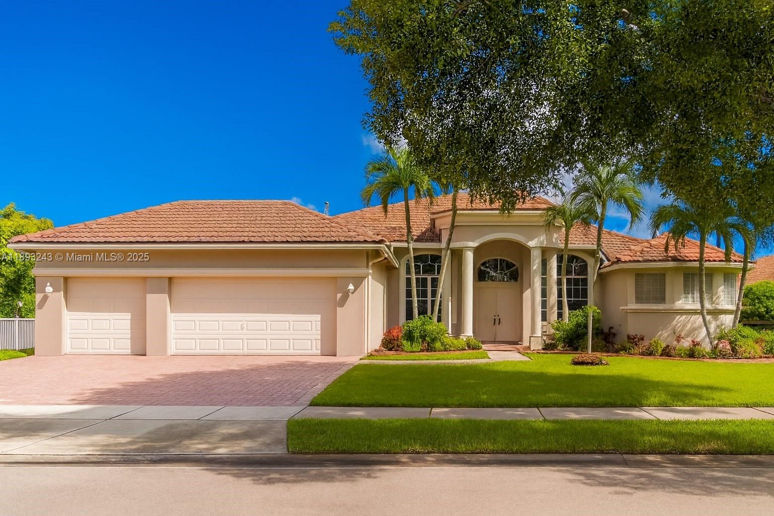 14032 Northwest 15th Street Pembroke Pines, FL 33028 - Photo 36 of 55 a front view of a house with a garden and trees