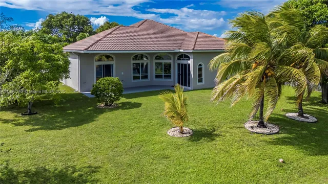 a front view of a house with a garden and yard