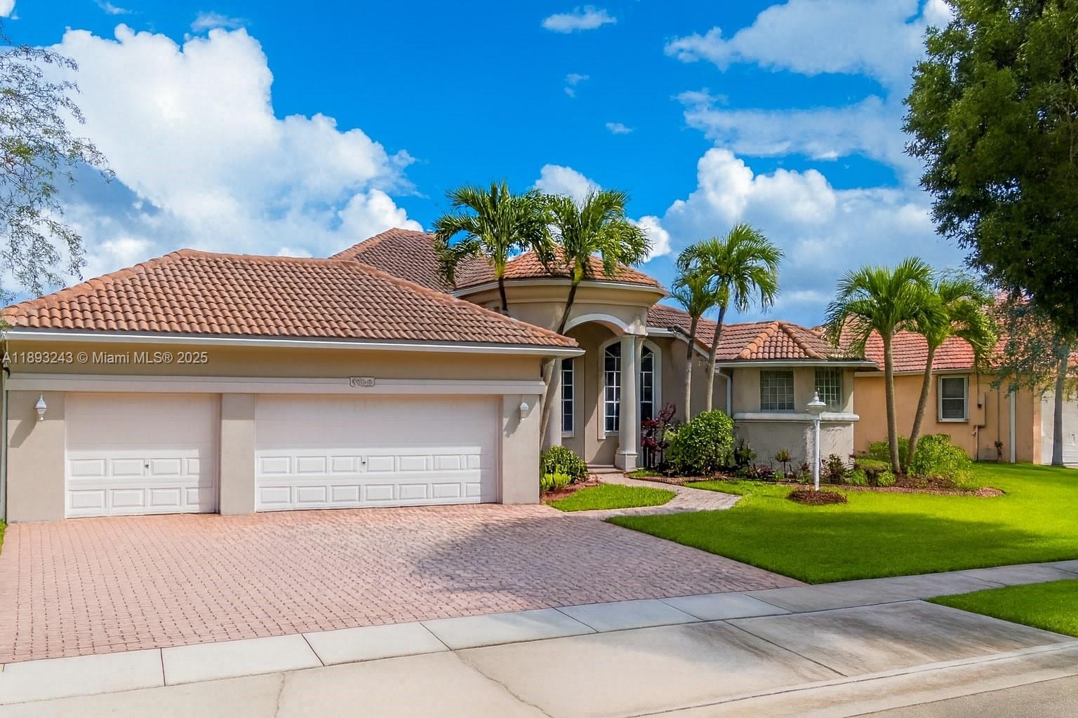 14032 Northwest 15th Street Pembroke Pines, FL 33028 - Photo 42 of 55 a front view of a house with a yard and garage