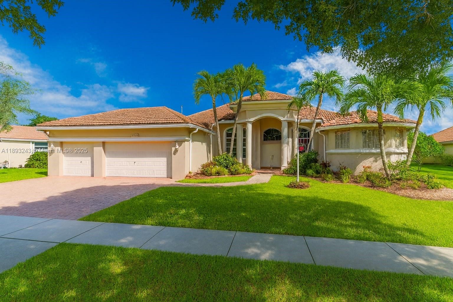 14032 Northwest 15th Street Pembroke Pines, FL 33028 - Photo 43 of 55 a front view of a house with a garden and yard