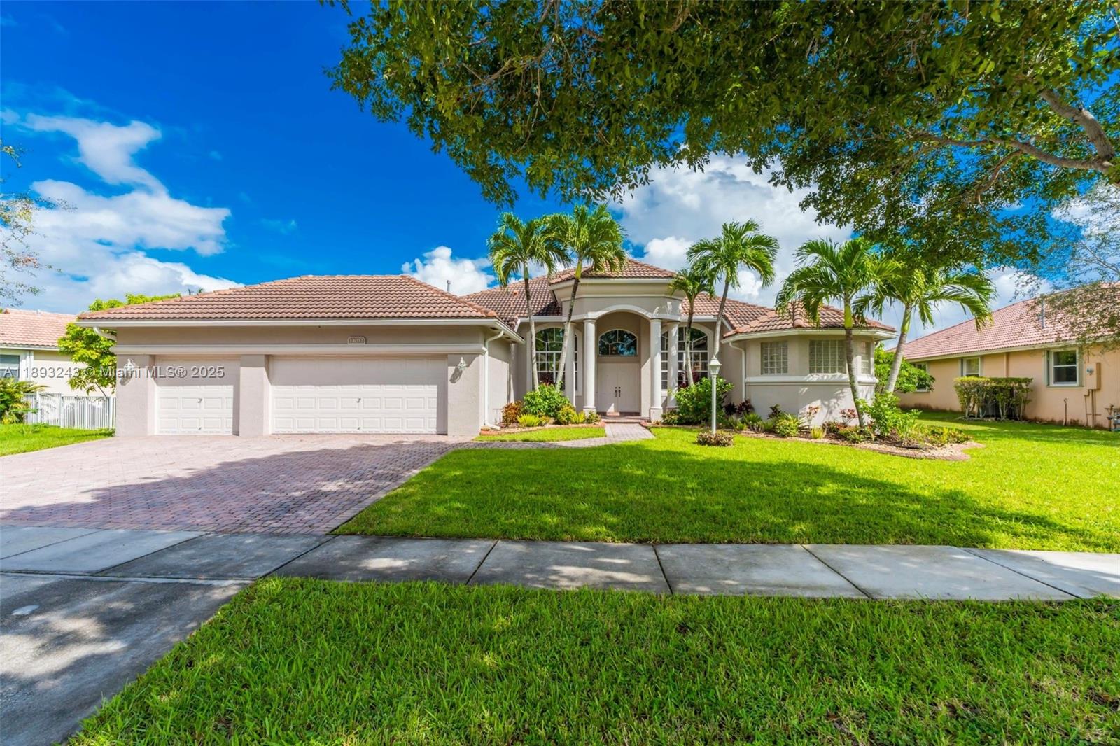 14032 Northwest 15th Street Pembroke Pines, FL 33028 - Photo 44 of 55 a front view of a house with a yard and garage