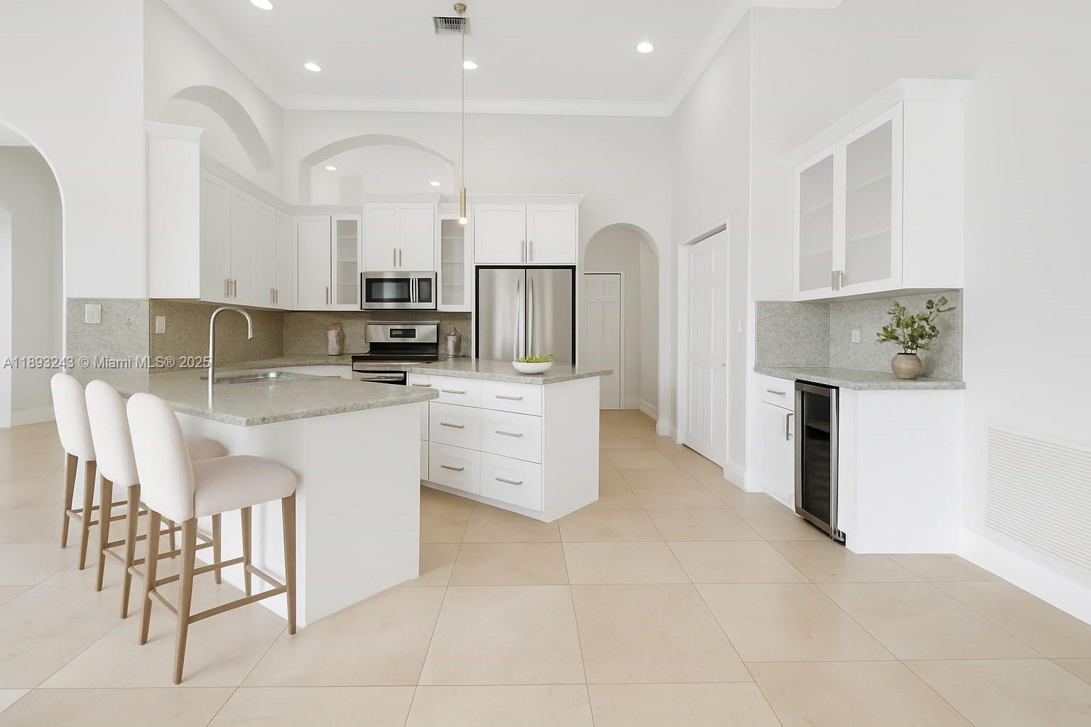 14032 Northwest 15th Street Pembroke Pines, FL 33028 - Photo 5 of 55 a kitchen with stainless steel appliances a refrigerator sink and cabinets