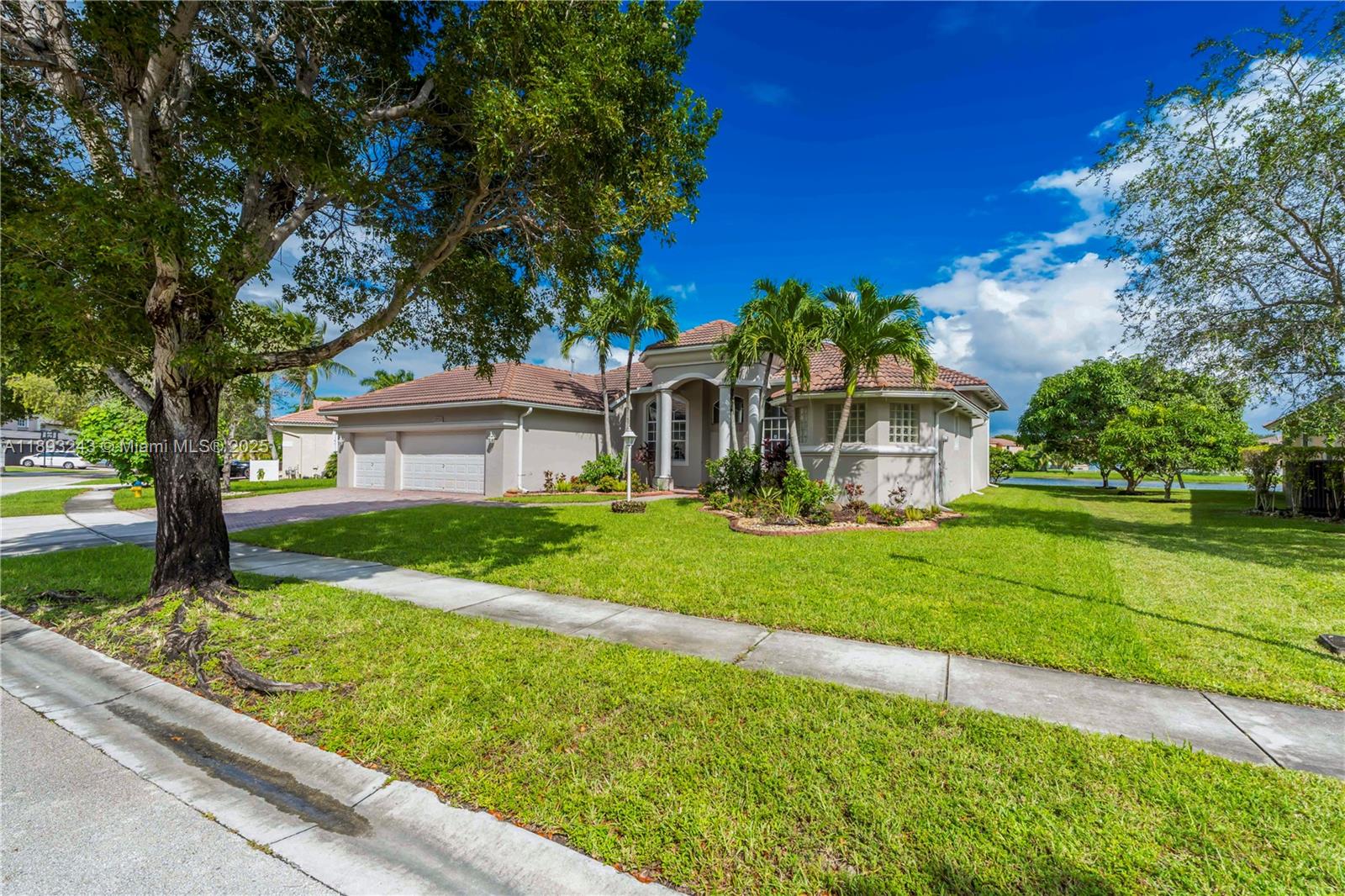 14032 Northwest 15th Street Pembroke Pines, FL 33028 - Photo 53 of 55 a front view of a house with garden