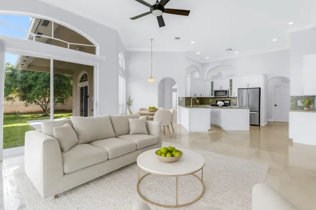 a living room with furniture and kitchen view
