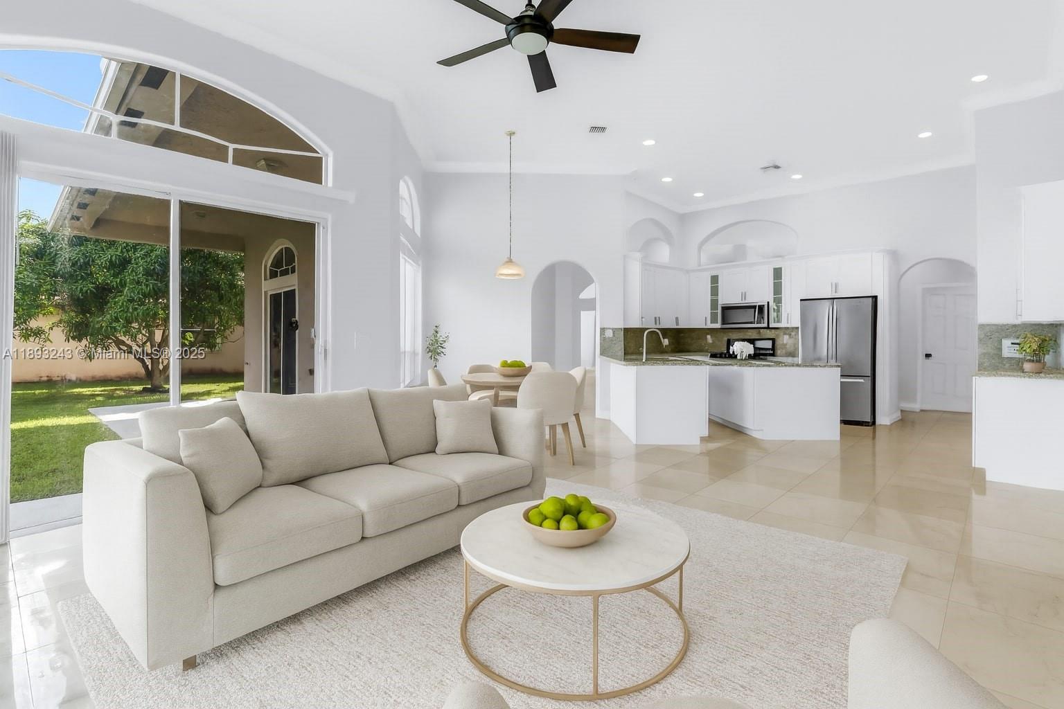 14032 Northwest 15th Street Pembroke Pines, FL 33028 - Photo 8 of 55 a living room with furniture and a large window with garden view