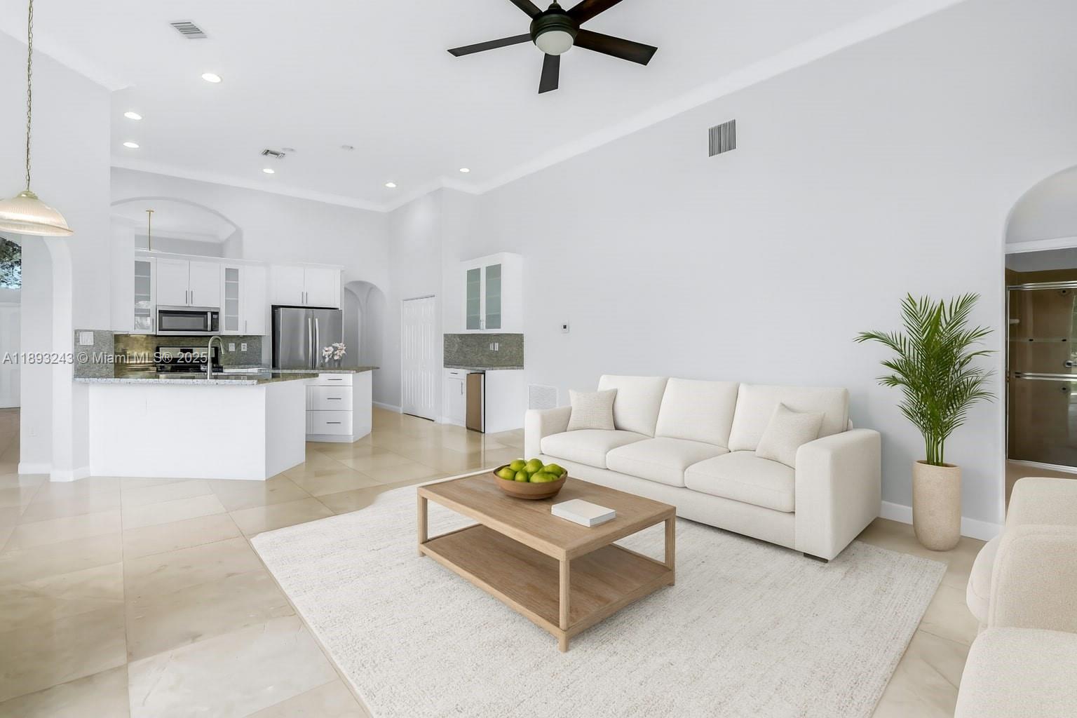 14032 Northwest 15th Street Pembroke Pines, FL 33028 - Photo 10 of 55 a living room with furniture and kitchen view