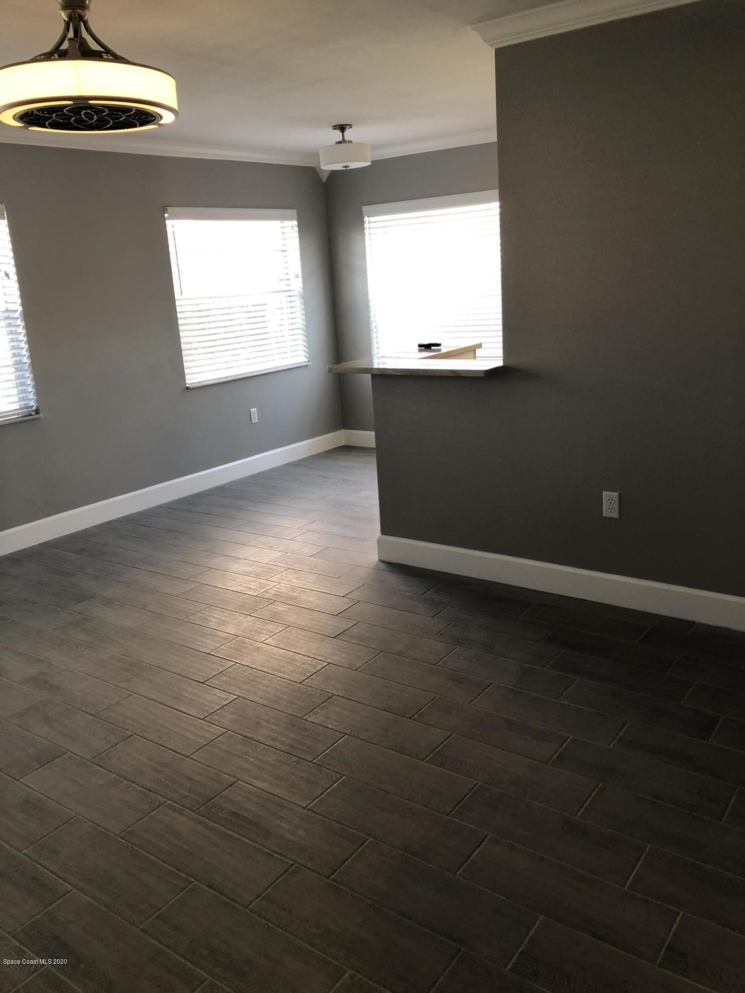 420 Monroe Avenue, Unit 101 Cape Canaveral, FL 32920 - Photo 11 of 35 an empty room with windows