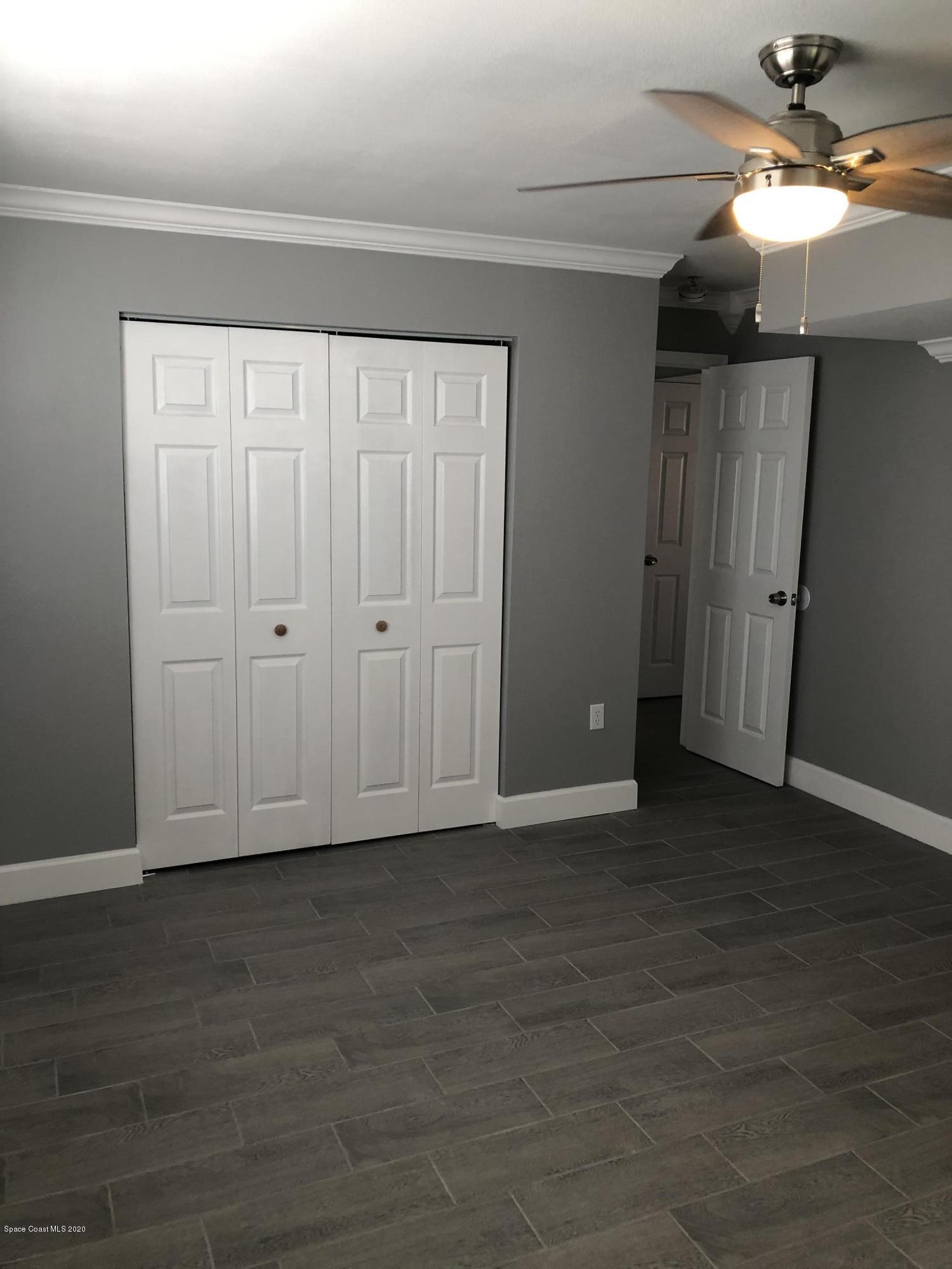 420 Monroe Avenue, Unit 101 Cape Canaveral, FL 32920 - Photo 14 of 35 a view of an empty room with wooden floor