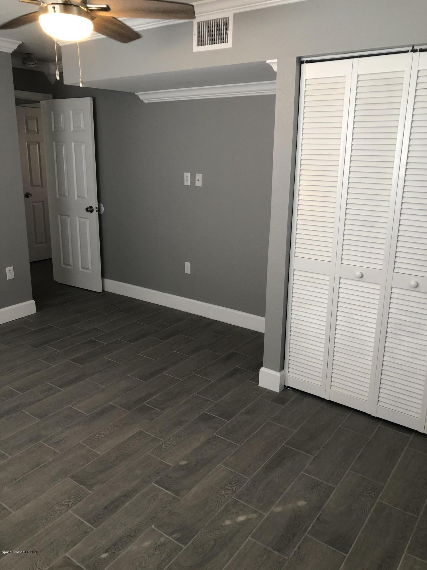 420 Monroe Avenue, Unit 101 Cape Canaveral, FL 32920 - Photo 15 of 35 an empty room with wooden floor