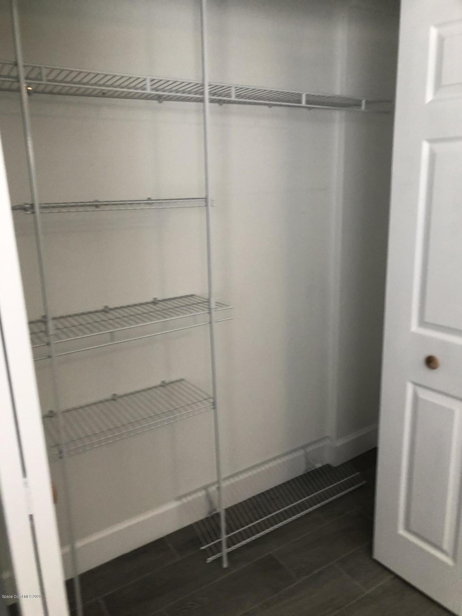 420 Monroe Avenue, Unit 101 Cape Canaveral, FL 32920 - Photo 19 of 35 a view of an empty walk in closet