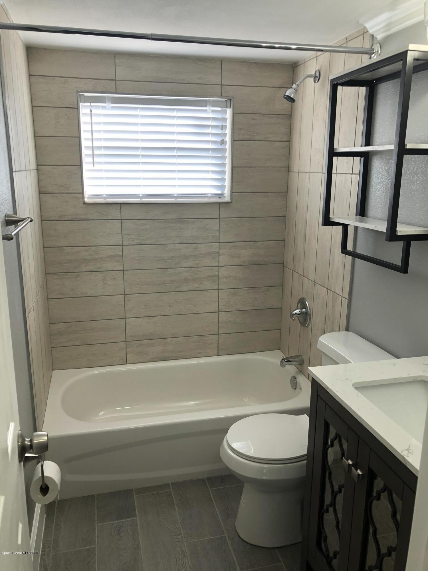 420 Monroe Avenue, Unit 101 Cape Canaveral, FL 32920 - Photo 22 of 35 a bathroom with a sink a toilet and shower