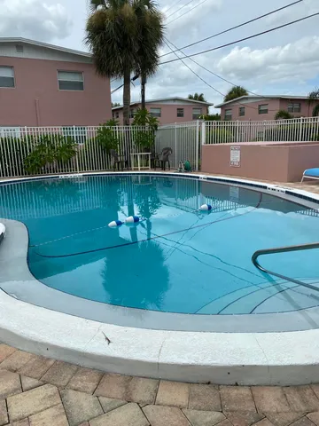 a view of a swimming pool with a yard