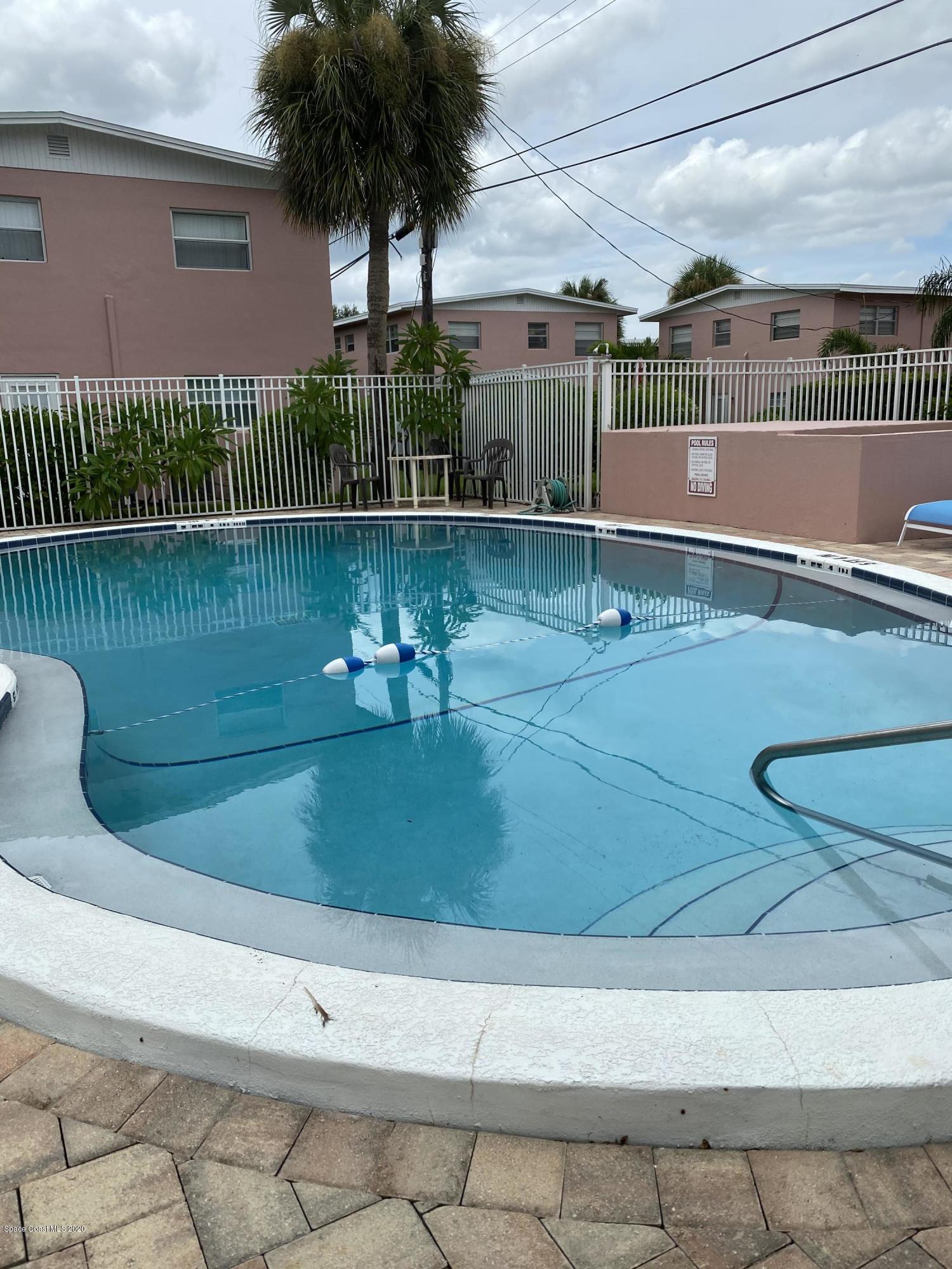 420 Monroe Avenue, Unit 101 Cape Canaveral, FL 32920 - Photo 24 of 35 a view of a swimming pool with a yard