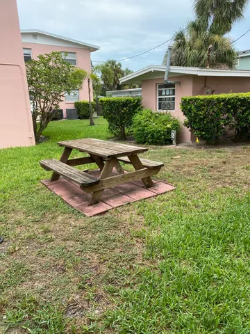a view of a backyard with a table and chairs