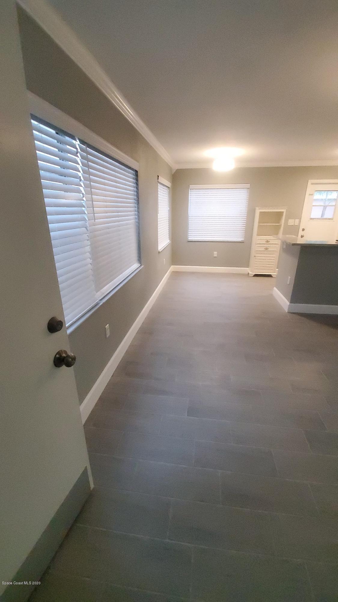 420 Monroe Avenue, Unit 101 Cape Canaveral, FL 32920 - Photo 3 of 35 a view of empty room with wooden floor and fan