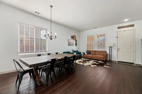 a view of a workspace with furniture window and wooden floor
