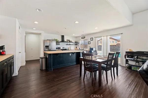 a view of kitchen with cabinets table and chairs