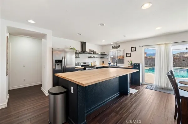 a large kitchen with stainless steel appliances a sink stove and refrigerator