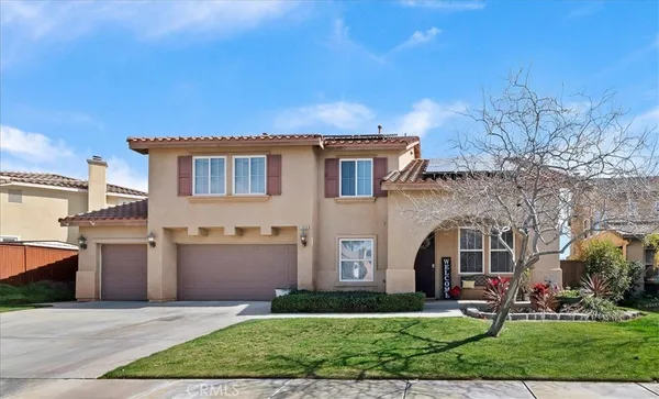 a front view of a house with a yard and a garage