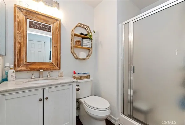 a bathroom with a toilet a sink and a mirror