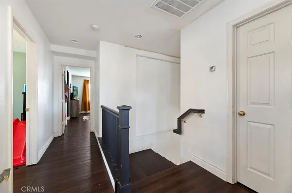 a view of hallway with wooden floor