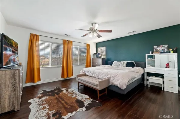 a spacious bedroom with a bed and a chandelier