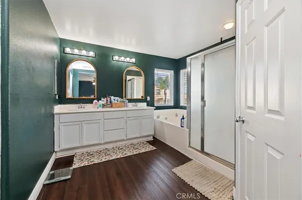 a spacious bathroom with a double vanity sink and mirror