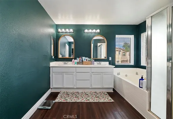 a bathroom with a sink a large mirror and a bathtub