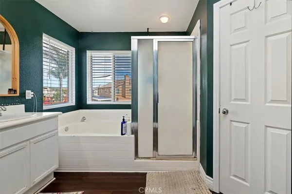 a view of bathroom with bathtub and window