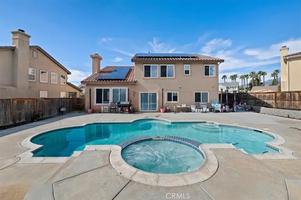 a view of a house with swimming pool and a yard