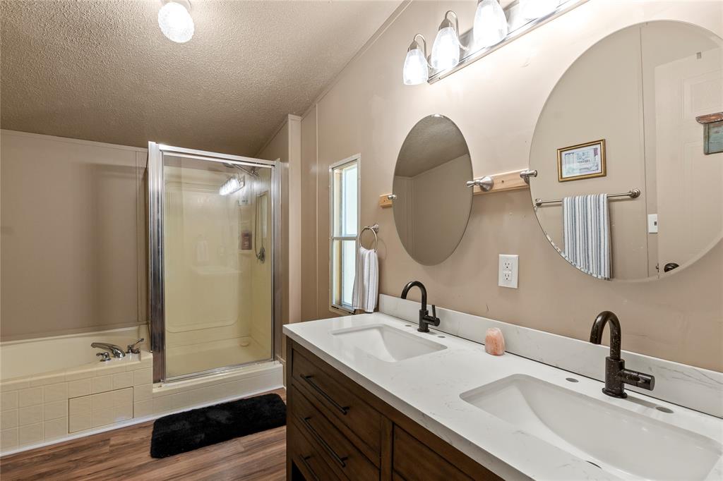194 Indian Gap Road Mabank, TX 75156 - Photo 10 of 18 a bathroom with a tub sink and mirror