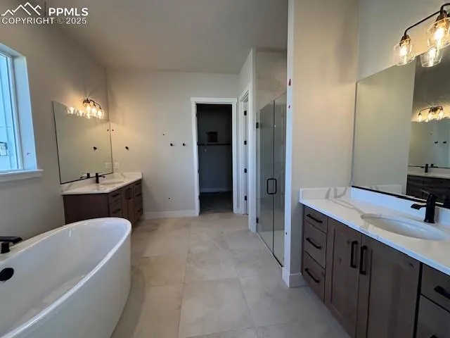 a bathroom with a sink a tub and a mirror