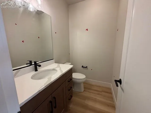 a bathroom with a sink and mirror with toilet