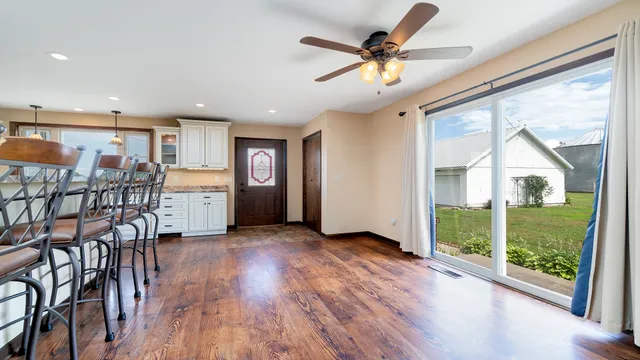a view of a livingroom with furniture window wooden floor and garden view