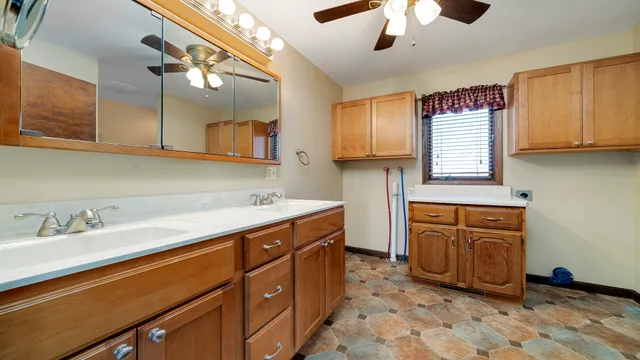 a kitchen with a sink cabinets and window