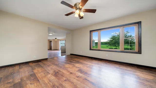 wooden floor in an empty room with a window