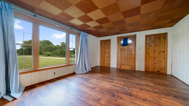 a view of livingroom with wooden floor and a large window
