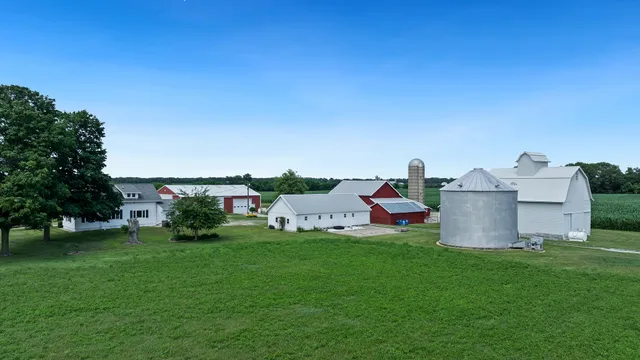 a view of a house with a yard and sitting area