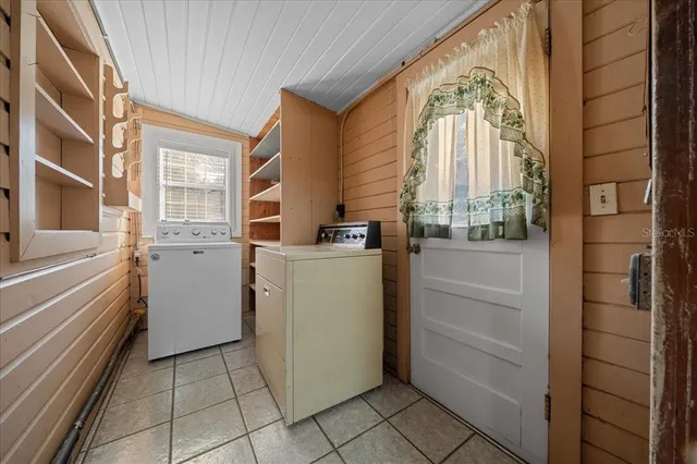 a view of backyard of house with green space