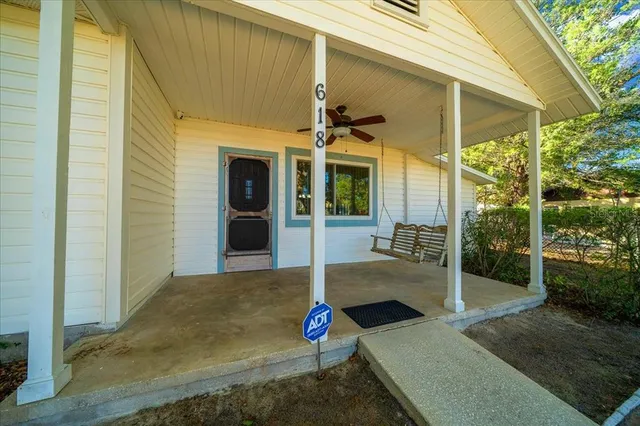 a kitchen with a refrigerator a stove top oven and cabinets