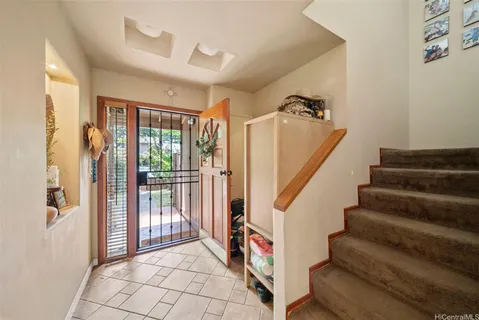 a view of entryway with stairs and wooden floor