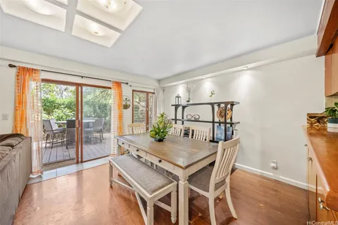 a dining room with furniture and wooden floor