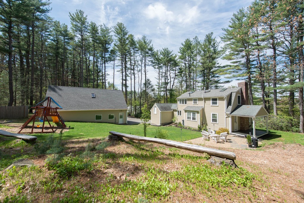 a aerial view of a house with swimming pool garden and patio