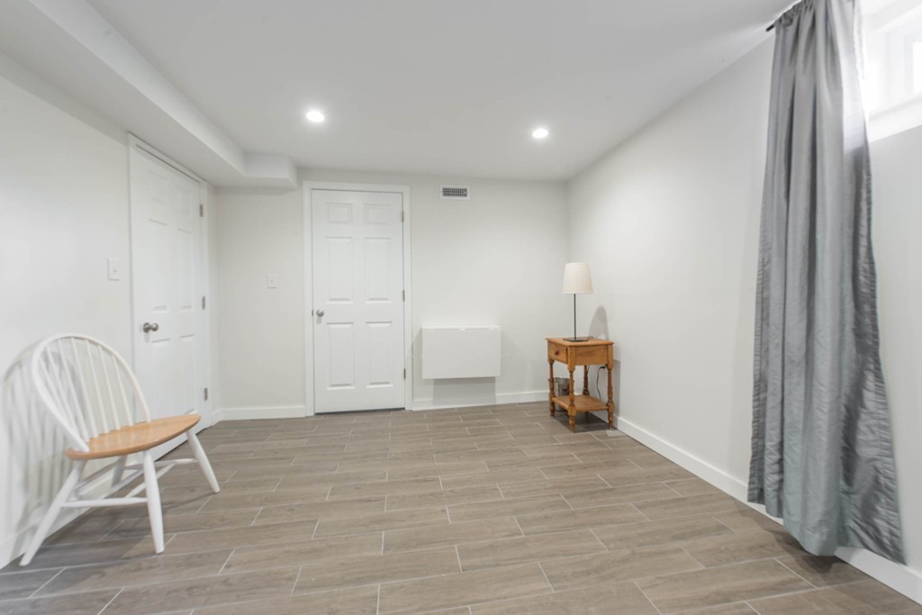9 Legion Road Weston, MA 02493 - Photo 24 of 30 a view of an empty room with wooden floor and a window
