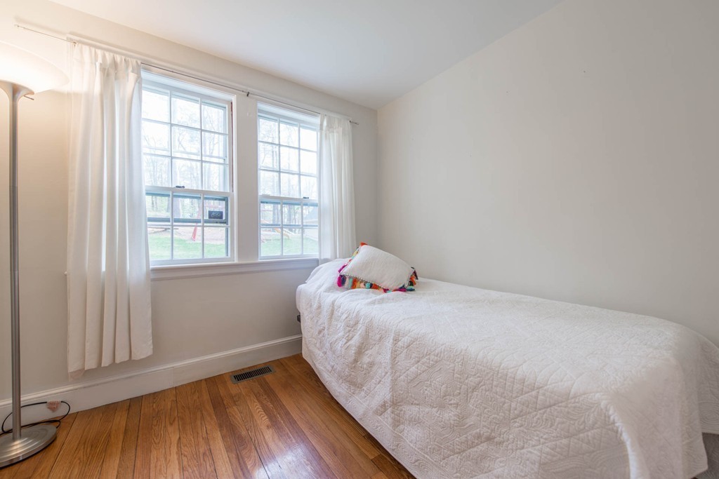 9 Legion Road Weston, MA 02493 - Photo 26 of 30 a bedroom with a bed and wooden floor